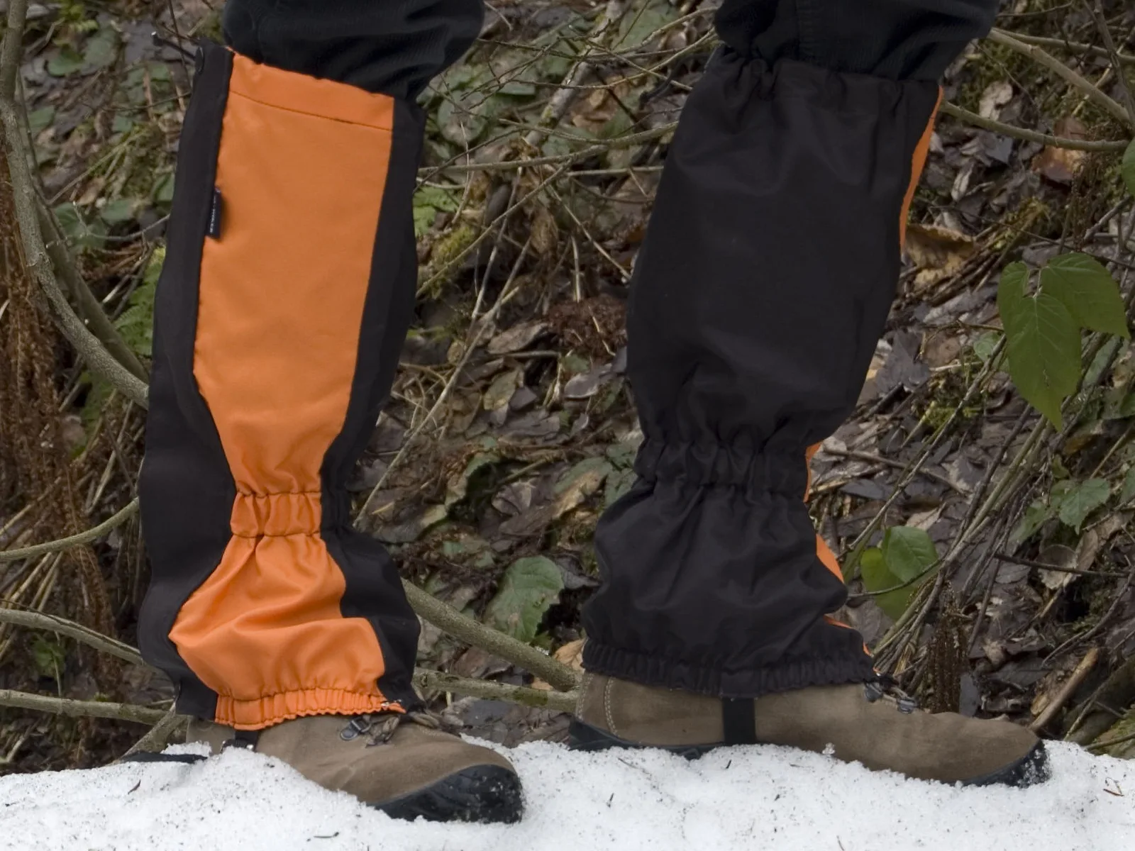 Permethrin-treated tick-prevention gaiters worn over the lower legs